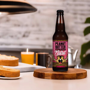 Cerveza Belching Beaver Peanut Butter Milk Stout Nitro sobre madera